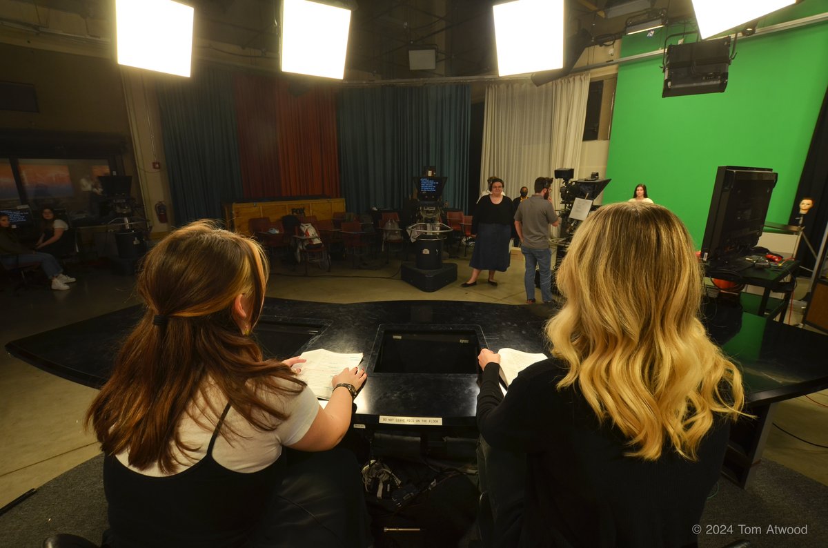 Students working in the SIUE television studio with green screen and professional lighting
