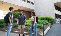 SIUE Students meeting outside of Alumni and Founders Halls on a sunny day.