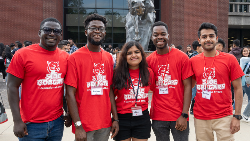 SIUE Students in red shirts in front of the Morris University Center.