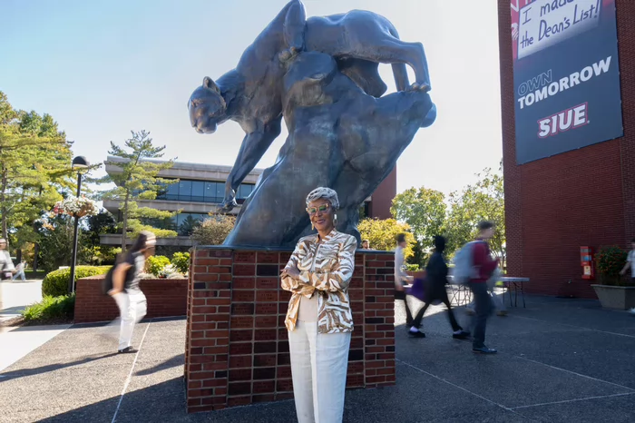 Earleen Patterson standing infrond of the MUC building