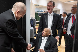 SIU President Dan Mahoney greets Reginald Petty and Blair Kamin.