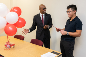 Chancellor James T. Minor, PhD, presents Pham the Student Employee of the Year award.