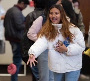 International student tosses a cornhole bag