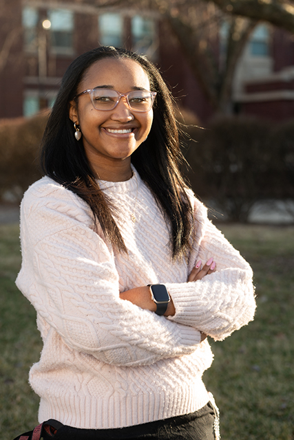 Portrait of Kiya Rainey standing outside Woodland Hall