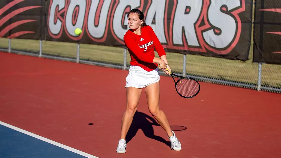 tennis player Gorman backhanding a tennis ball on a court