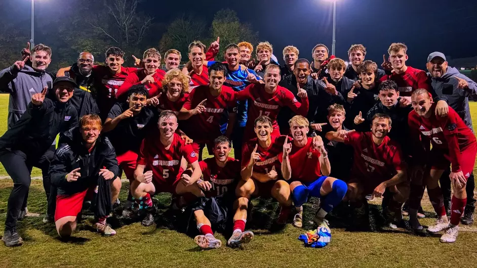 landscape photo of the men's soccer team at night on the pitch