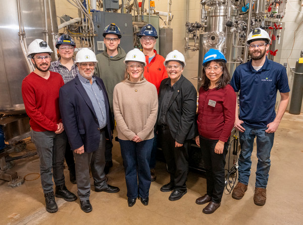 Group photo in hardhats at fermentation plant