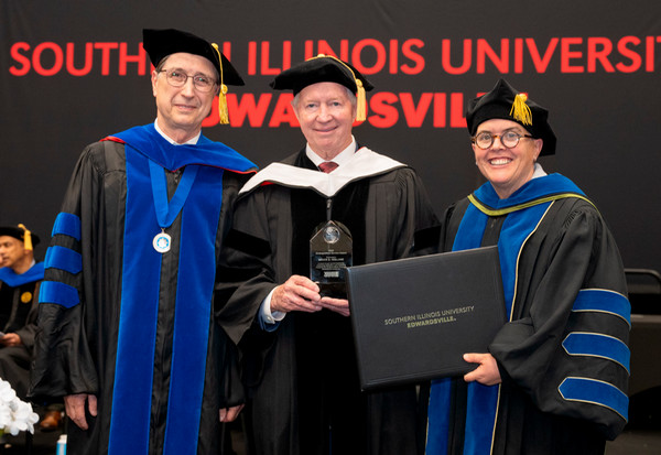Bruce Holland stands between Dean Karacal and Provost Cobb