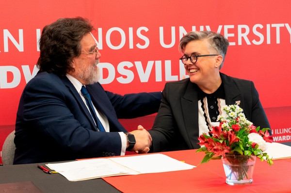 Dr Patricio and Provost Cobb shaking hands about agreement