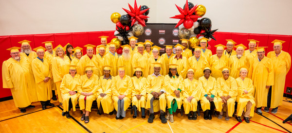 Golden Graduates dressed in commencement robes pose for photo