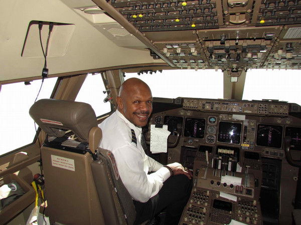 Golden Graduate Latham in airplane cockpit