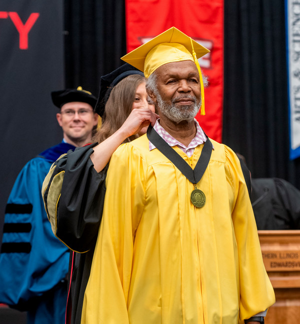 Mr Elester Latham gets commencement golden graduates medal