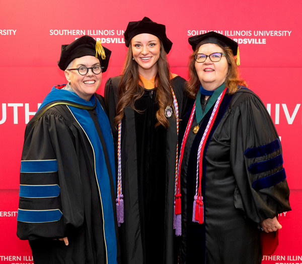 Kaitlyn Harris stands in between Provost Cobb and Dean Judy