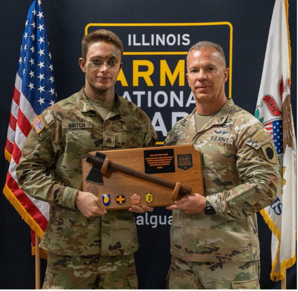 Two military men holding Sgt Birtch award