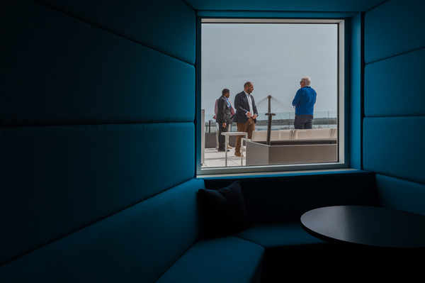 Shot of people on balcony through interior room of The Wedge