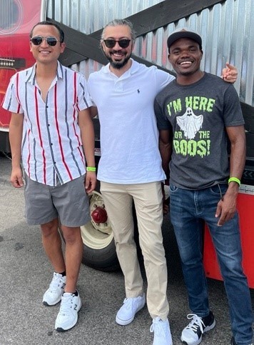  Hamid Rostami, Suraj Bhandari, and James Kore-Quaye standing for a photo together smiling