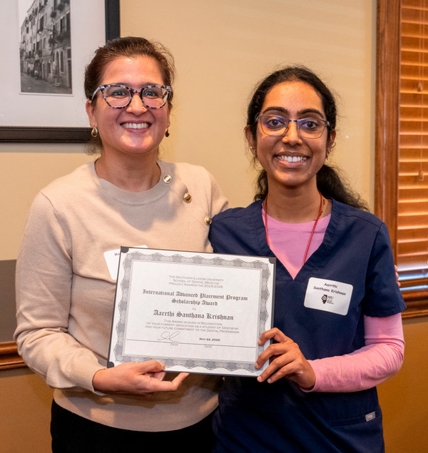 Two women holding award