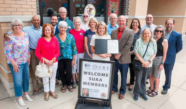 State Sen Harris surrounded by SIUE SUAA chapter members holds resolution