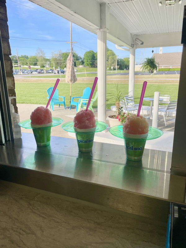 Three sno cones on a counter