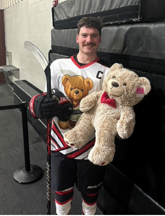 Ice Hockey Captain with big teddy bear