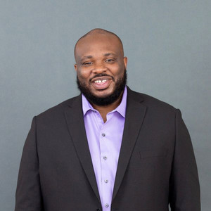 portrait of Jason Frazier in a suit