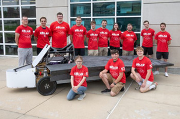 photo of the 2025 solar car team from the school of engineering standing alongside their vehicle