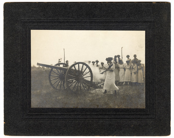 Women in long dresses load and fire cannon 