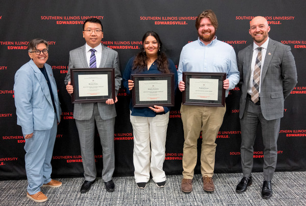 Provost Students and Dean pose with students holding their framed awards