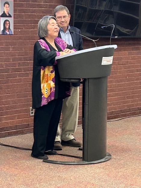 Julia and Stephen Hansen stand at podium