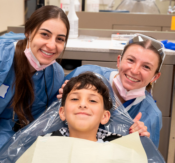 Kazan in dentist chair with dental practitioners