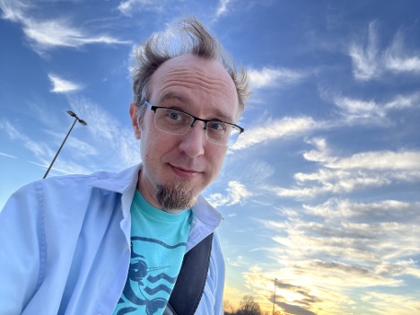 Low and canted angle shot of Jason Finley beneath the sky