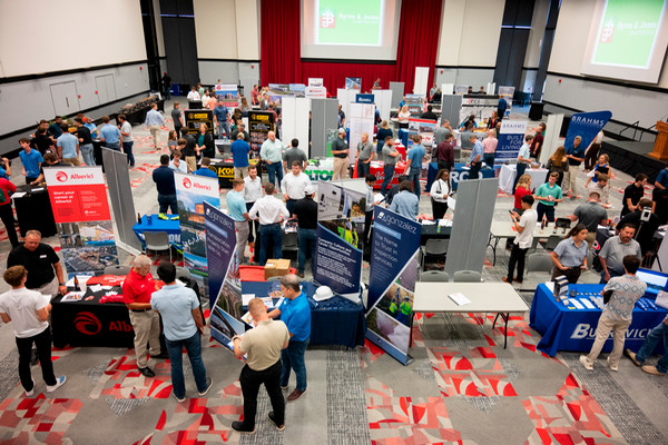 Birds eye photo of people networking on conference room floor