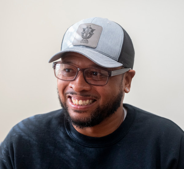 Ikenya Magram looks left off camera smiling