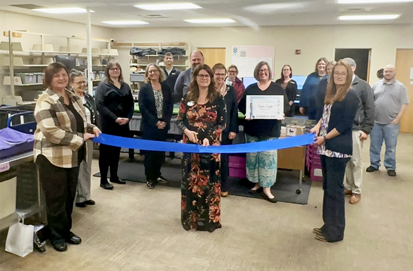 Group surround ribbon ready to cut for ribbon cutting ceremony