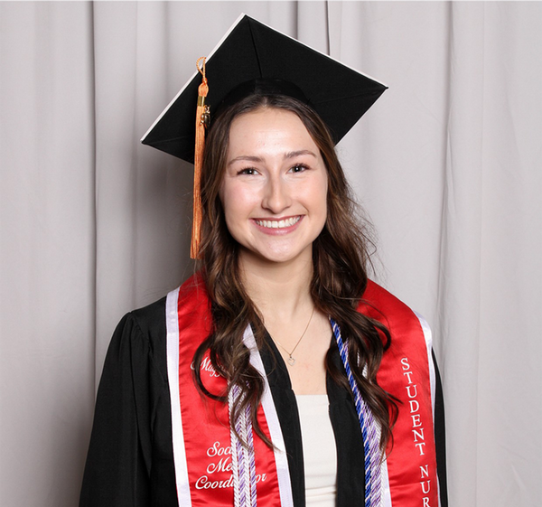 Margaret Holthaus in cap and gown facing camera
