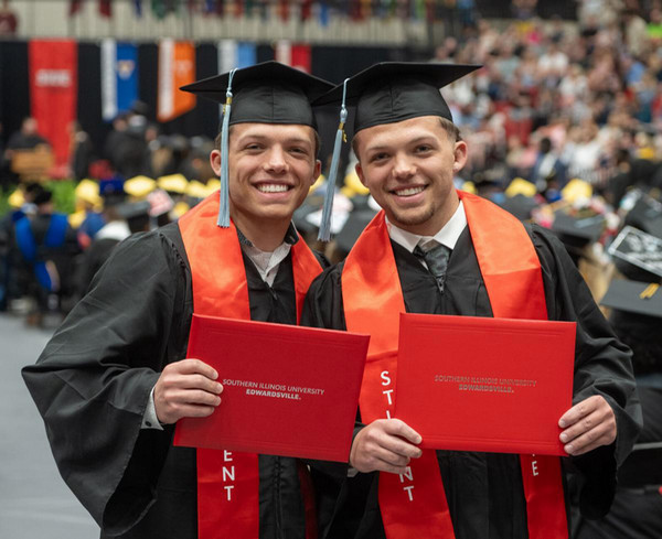 SIUE wrestlers Caleb Tyus, left, and Caine Tyus show off their diplomas at SIUE commencement