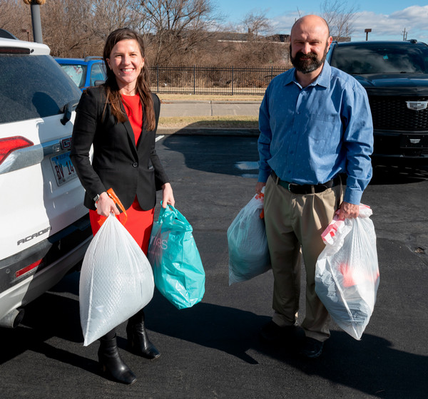 Rep. Schmidt and Emma Pieper with the clothing items to be donated