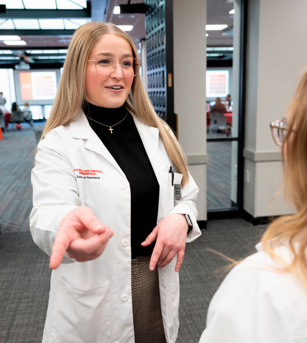 Karigan Harvey portrait in white lab coat at diabetes symposium