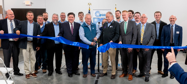 Row of individuals w Gov Pritzker cutting large ribbon