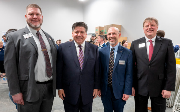 Three SIUE faculty members pose with Gov JB Pritzker