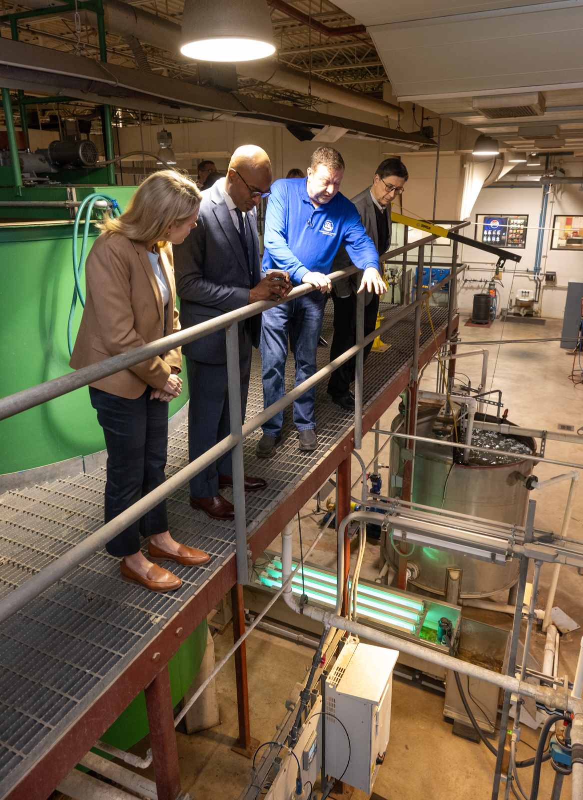 Illinois State Senator Erica Harriss and visitors stand on a platform overlooking water treatment equipment during a tour of SIUE’s Environmental Resources Training Center.