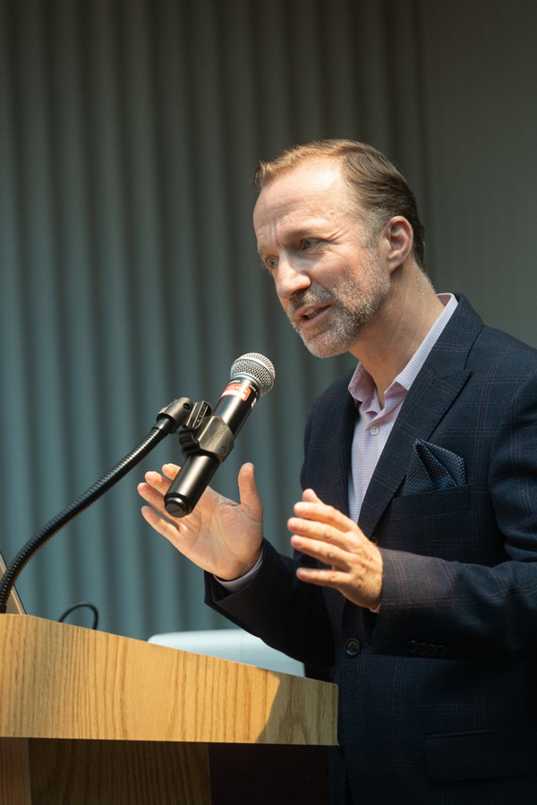 Dr Celik at podium speaking