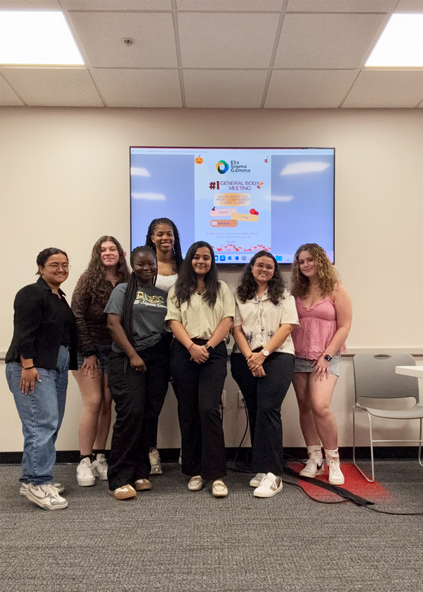 Seven award winners stand together to pose for photo