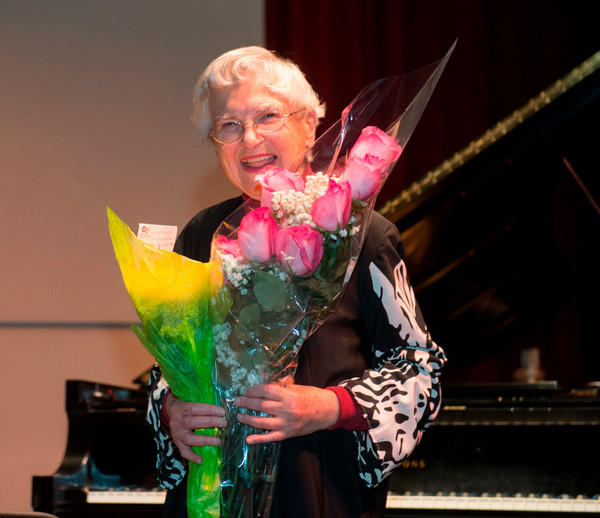 Ruth Slenczynska standing and holding flower bouquet