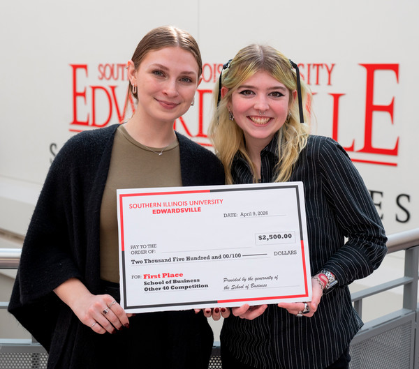 The Other 40 first place winners two students holding their award and facing camera