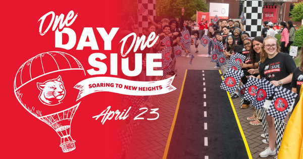 Students line a campus walkway holding checkered flags during One Day, One SIUE Day of Giving event, with bold graphic text “One Day, One SIUE – Soaring to New Heights, April 23.”