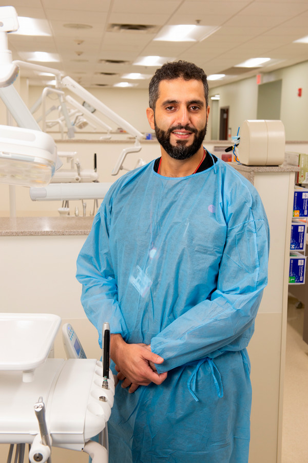 Portrait of Dr Mohamed Omran Alfaituori in scrubs