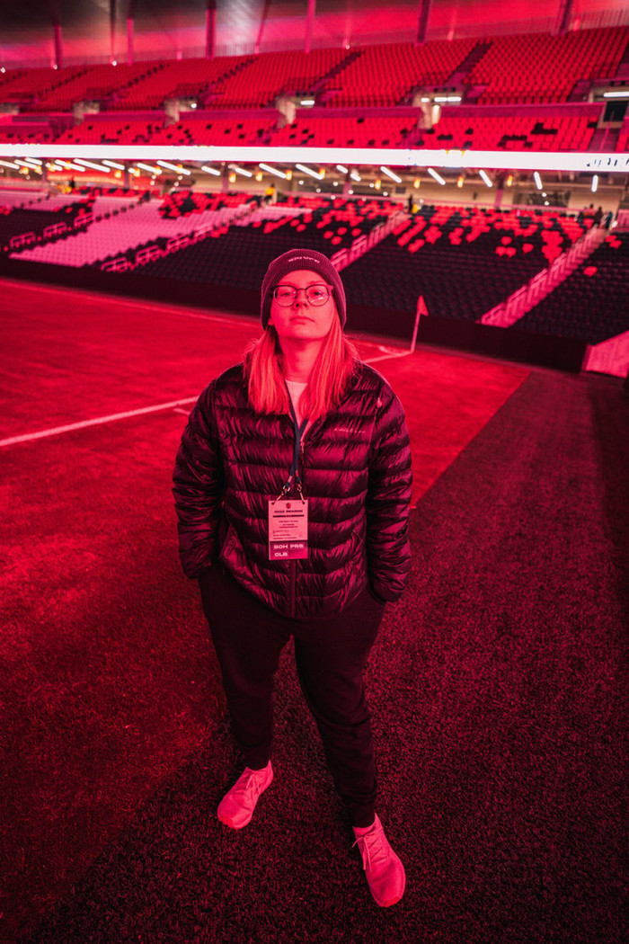 a woman is standing in s stadium