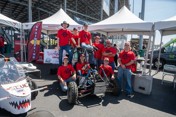 Cougar Baja Team surround their vehicle at tent at STEM Lane