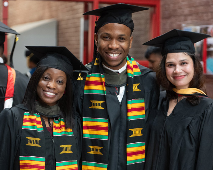 Three SIUE Graduates pose for camera at commencement